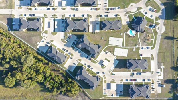 Aerial view of Liberty Crossing apartment buildings and parking areas