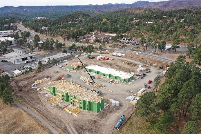 Construction crane lifting materials at the Elk Meadows multi-story building site